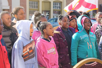 Macon County school children signing Macon County Veterans parade 2014