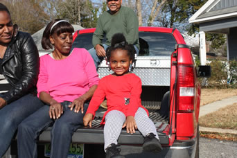 young girl on tailgate waiting for Santa