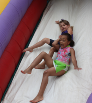 girls on a water slide inflatable